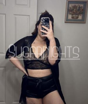 Carolina poses in a black lace bralette and matching satin shorts. Carolina poses in a black lace bralette and matching satin shorts.